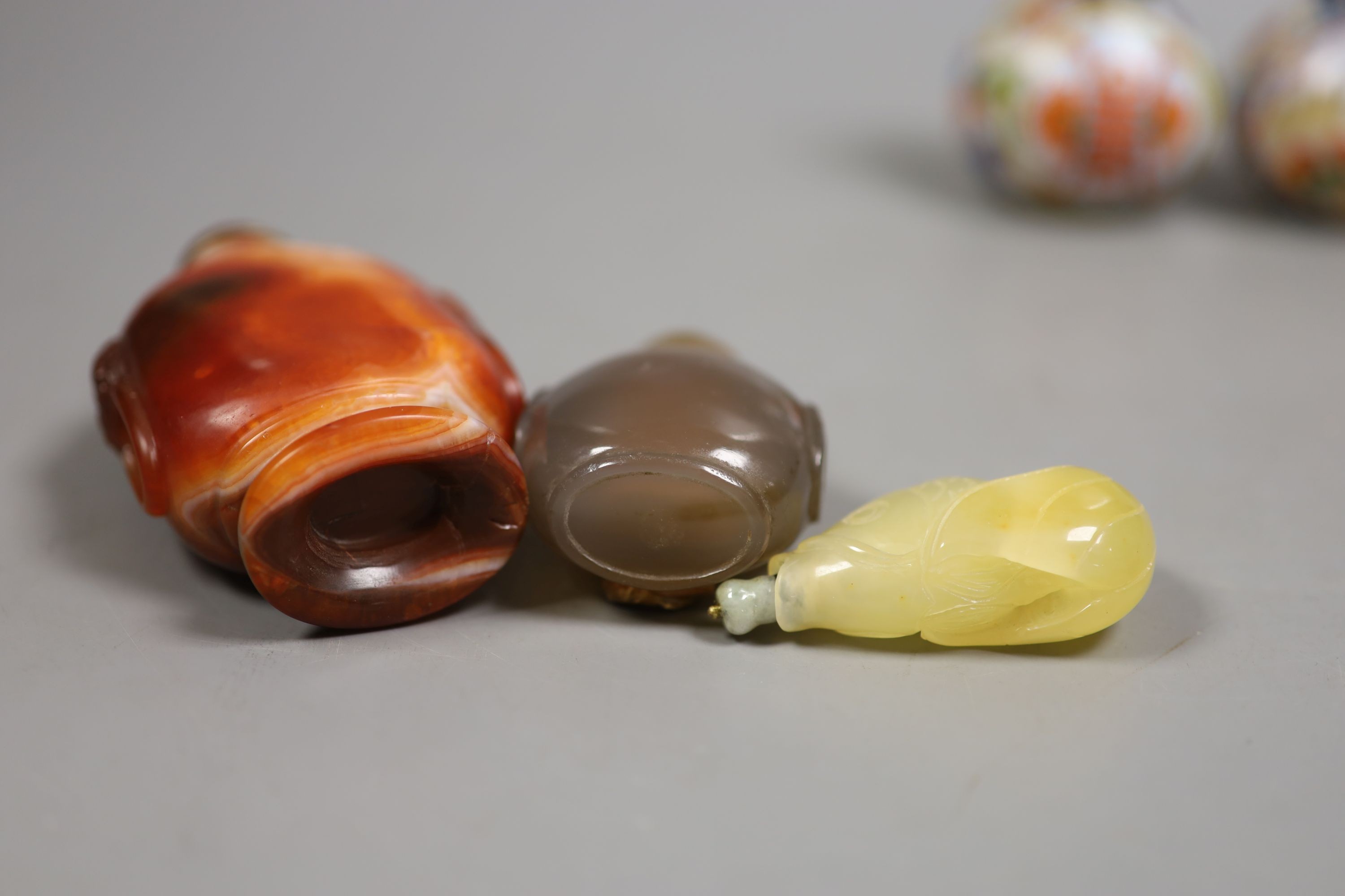 A group of Chinese jade, hardstone and glass snuff bottles, tallest 9.5 cm